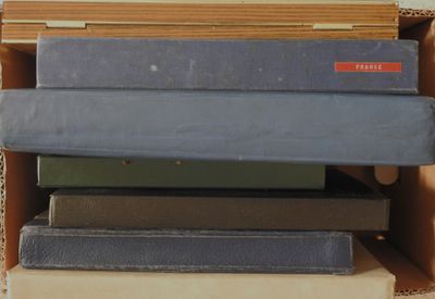 a stack of books sitting on top of a cardboard box