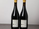 two bottles of wine sitting on top of a wooden table