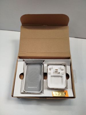 a box with a cell phone and a charger inside of it