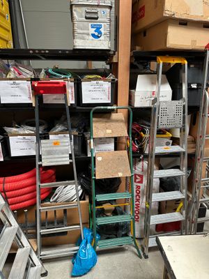a lot of boxes and ladders in a room
