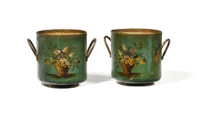 pair of green vases with flowers on them sitting on a table