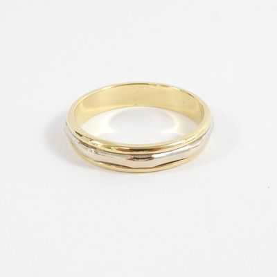 a close up of a gold ring on a white surface