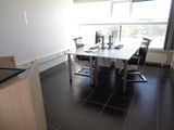 a desk with two computers on it in a room