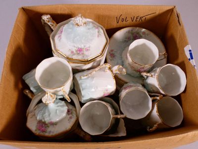 a box of tea cups and saucers that are in it
