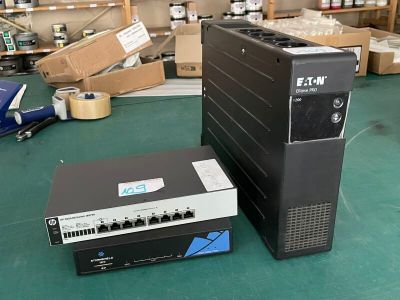 two computers that are sitting on a green table