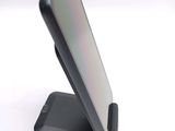 a cell phone on a stand on a white surface