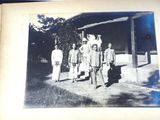 an old photo of a group of men standing in front of a building