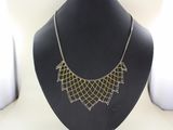 a close up of a necklace on a mannequin on a mannequin stand