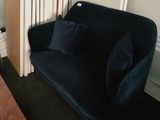 a couch and a table in a room with a radiator