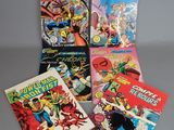 a group of comic books sitting on top of a table