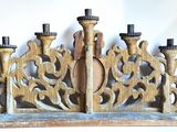 a wooden candle holder with candles on top of it