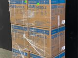 boxes stacked on a pallet in front of a black wall