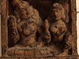 carvings of a woman and a child in a wooden frame