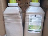 two bottles of liquid sitting in a cardboard box
