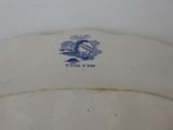 a blue and white plate with a picture of a house on it