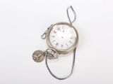 a silver pocket watch with a chain around it