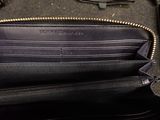 a black purse that is open on a table