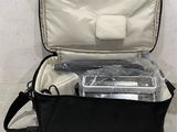 a black bag with some items in it on the floor