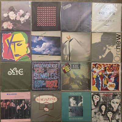 many different album covers on the wall of this room