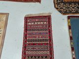 many rugs on the floor in a room