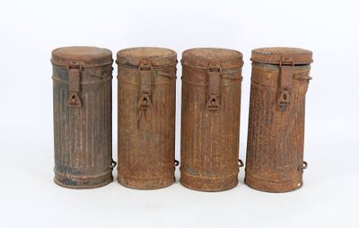 three old fashioned wooden containers are lined up on a white surface
