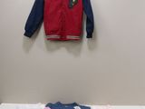 a baby boy ' s clothes on a table in a room