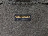 the back of a sweater with a geiger logo on it