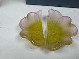 two pieces of glass sitting on top of a table