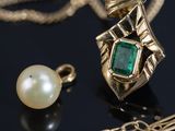 an image of a close up of a necklace and a pearl on a table