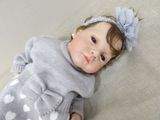 a baby doll that is laying down on the floor