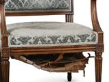 an old wooden chair with a green upholstered seat on a white background