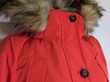 the jacket is red with a fur collar and a hood