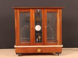 a clock that is sitting inside of a glass case