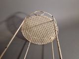 a basket that is hanging from the side of a chair