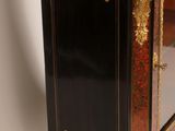a small cabinet with a mirror on top of it