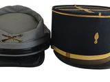 two hats are sitting next to each other on a white surface
