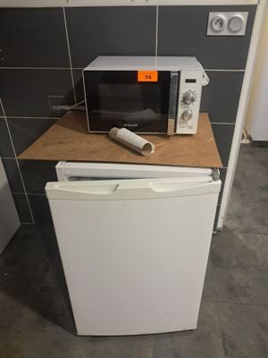 a microwave and a toaster sitting on a counter in a kitchen