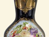 a black vase with a floral design on it