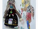 a picture of a doll and a doll on the wall