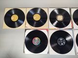 four black vinyl records sitting on top of each other on top of a table