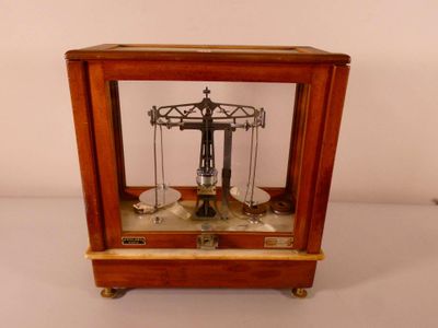 a small wooden clock with a pendulum on it