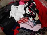 a pile of clothes that is sitting in a suitcase