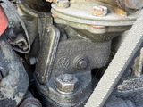 a close up view of an old engine with a hose