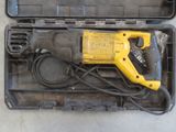 a yellow and black drill in a case on the floor