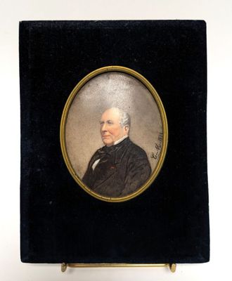 an old picture of a man in a black suit and tie