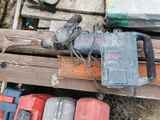 a hammer that is sitting on top of a pile of tools