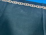 the back of a black dress with gold chains on it