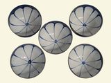 four white and blue bowls with blue designs on them on a white surface