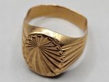 a close up of a gold ring on a white surface