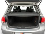 the back of a silver car with its trunk open and the back seats down
